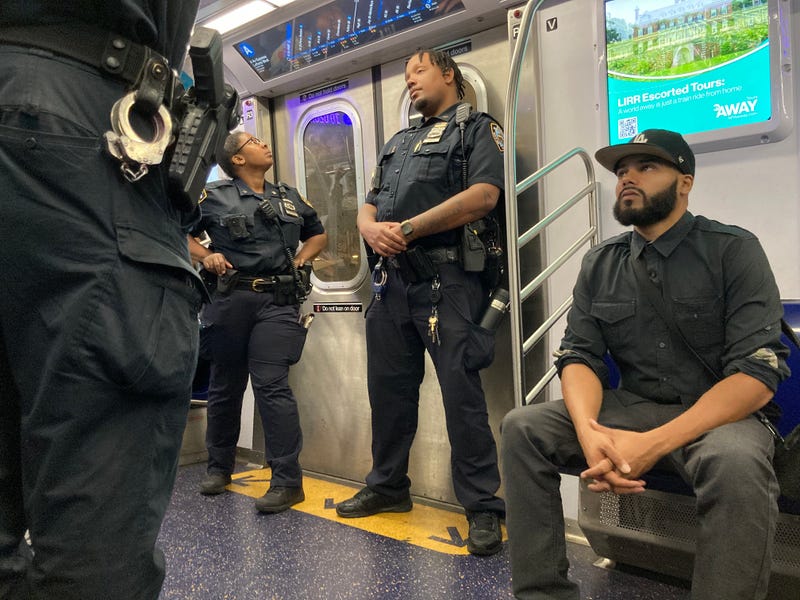 NYPD officers patrol an A train in Manhattan