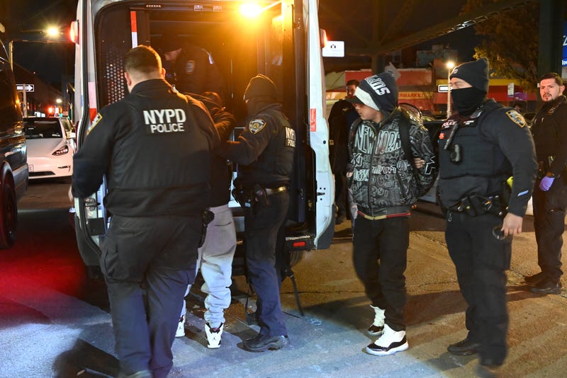 Men are taken into custody at the scene on Dec. 22, 2024