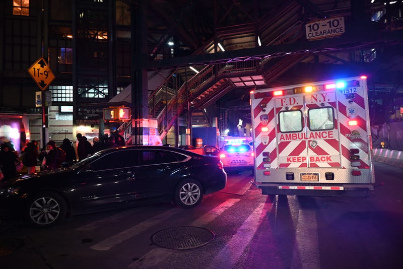Police and EMS are seen outside the 61st Street–Woodside station after the stabbing on Dec. 22, 2024