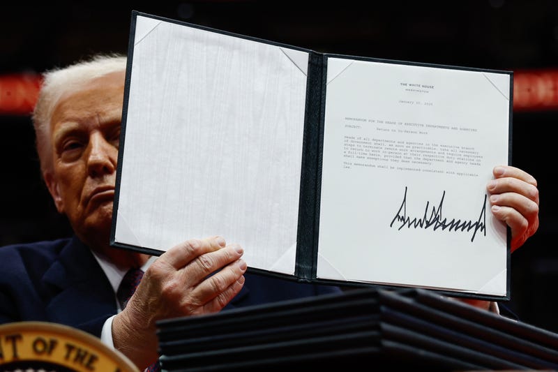 U.S. President Donald Trump holds up an executive order after signing it during an indoor inauguration parade at Capital One Arena on January 20, 2025 in Washington, DC. Donald Trump takes office for his second term as the 47th president of the United States. 