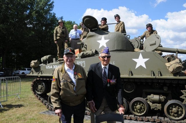 Veterans Clarence Smoyer and Joe Caserta stand near a Pershing tank