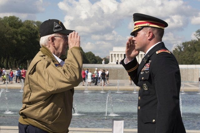 Army Maj. Peter Semanoff salutes World War II veteran Clarence Smoyer