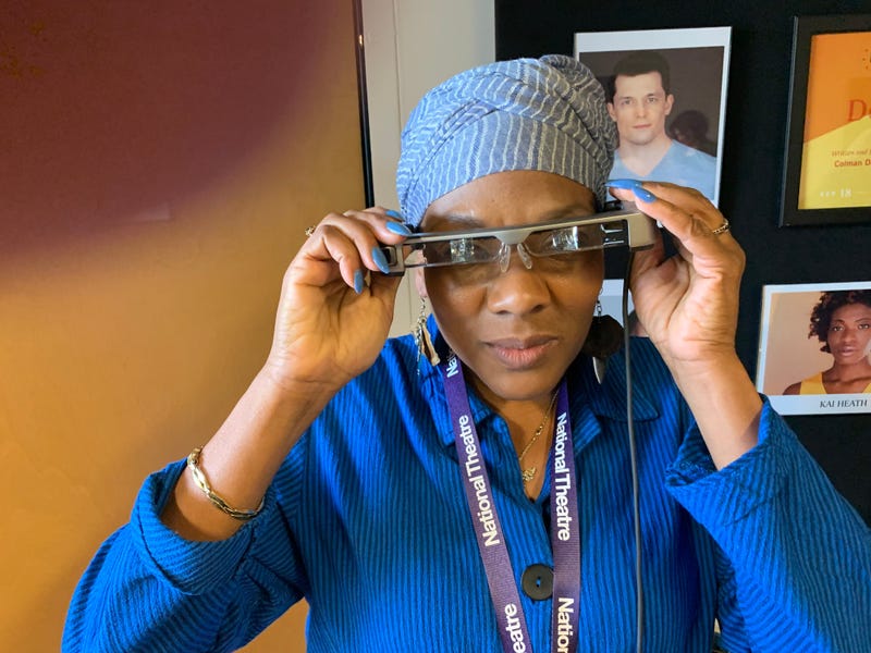 Cheryl Johnson, West Philadelphia, who suffers from hearing loss, puts on her smart caption glasses which she described as "amazing" in helping her to follow the performance of "Dot" at People's Light in Malvern, Chester County.