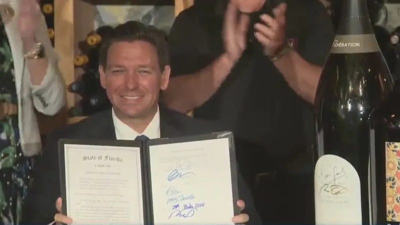 Gov. Ron DeSantis and a comically-large wine bottle