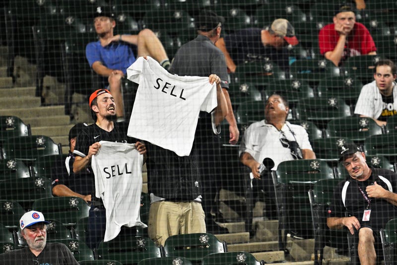 disgruntled White Sox fans, with signs that say "SELL"