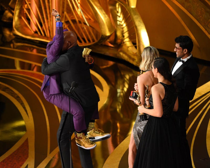 Samuel L. Jackson hugs Spike Lee after his Best Adapted Screenplay award at the 2019 Oscars