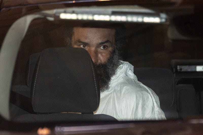 Ramon Rivera, a suspect arrested after multiple people were stabbed early Monday, is escorted out by NYPD officers at the NYPD 10th Precinct in New York, Monday, Nov. 18, 2024.