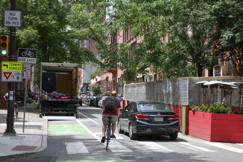 Man rides bike on Center City street