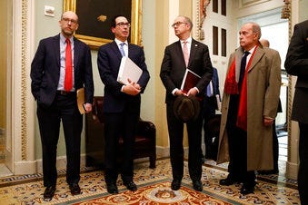 Treasury Secretary Steve Mnuchin, second from left, speaks with members of the media as he departs a meeting with Senate Republicans on an economic lifeline for Americans affected by the coronavirus outbreak. (AP Photo/Patrick Semansky)