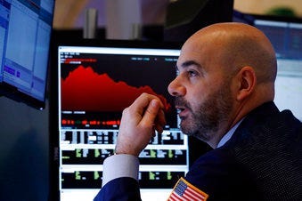 Trader Fred DeMarco works on the floor of the New York Stock Exchange, Friday, Feb. 28, 2020. Global stock markets are falling further on spreading virus fears. (AP Photo/Richard Drew)
