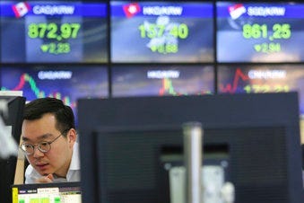 A currency trader watches monitors at the foreign exchange dealing room of the KEB Hana Bank headquarters in Seoul, South Korea, Wednesday, April 29, 2020. (AP Photo/Ahn Young-joon)