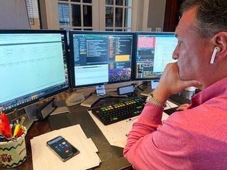 In this image, Jonathan Corpina, Senior Managing Partner at Meridian Equity Partners Inc., who normally works on the New York Stock Exchange trading floor, works in his home office. (Danielle Corpina/Courtesy Jonathan Corpina via AP)