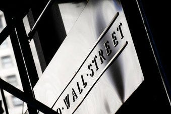 FILE - This July 15, 2013, file photo, shows a sign for Wall Street outside the New York Stock Exchange. (AP Photo/Mark Lennihan, File)