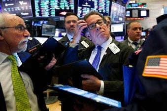 Sal Suarino, center, works with fellow traders on the floor of the New York Stock Exchange, Tuesday, March 10, 2020. (AP Photo/Richard Drew)