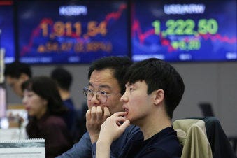 Currency traders watch monitors at the foreign exchange dealing room of the KEB Hana Bank headquarters in Seoul, South Korea, Friday, April 17, 2020. (AP Photo/Ahn Young-joon)