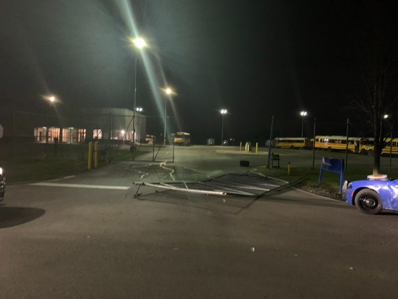 a gate is broken by a suspect who stole a school bus