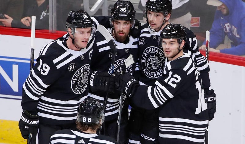 Blackhawks center Dylan Strome (17) celebrates with teammates after scoring against the Islanders.