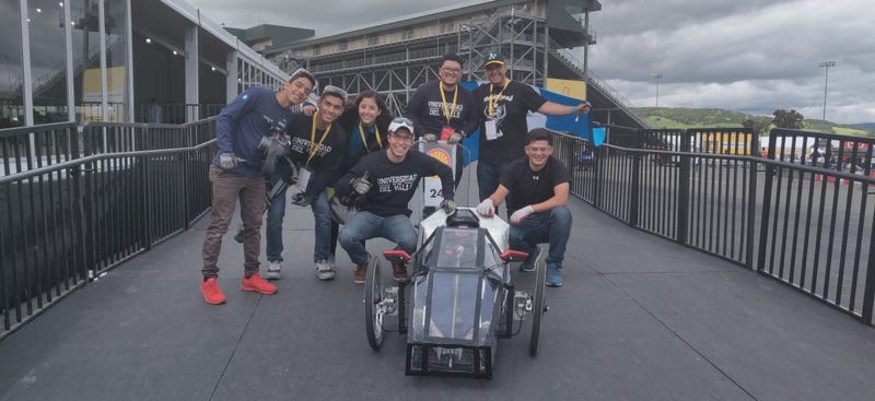 Guatemalan engineering students show off their entry into the Shell Eco-Marathon at Sonoma Raceway.