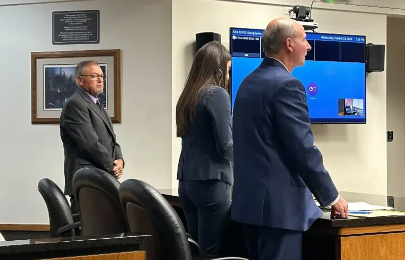 Timothy Daugherty, left, appears in an Oakland County courtroom, alongside his attorneys.