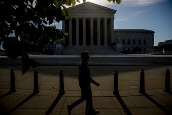 FILE - In this May 4, 2020, file a man walks past the Supreme Court in Washington. (AP Photo/Andrew Harnik, File)
