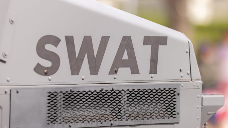 Close up of the Swat logo on the back of a Humvee