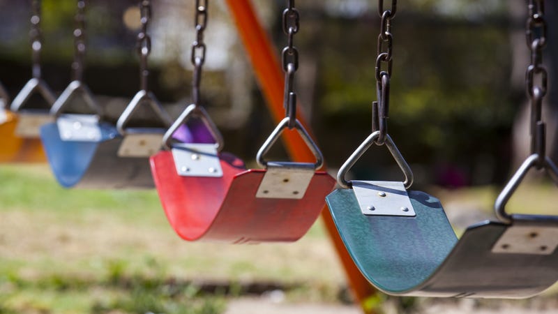 Row of empty, colorful swings