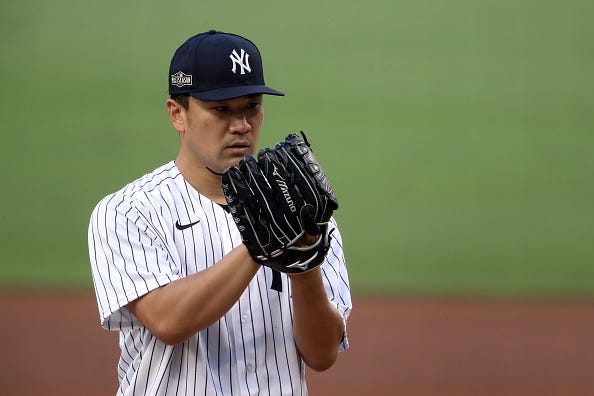 Masahiro Tanaka stares into the catcher during a Yankees playoff game. 