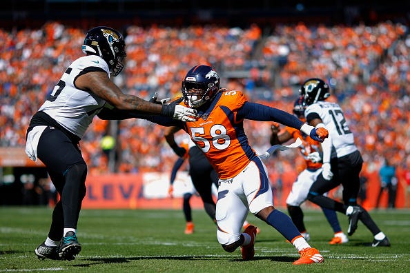 Jaguars tackle Jawaan Taylor attempts to block Von Miller. 