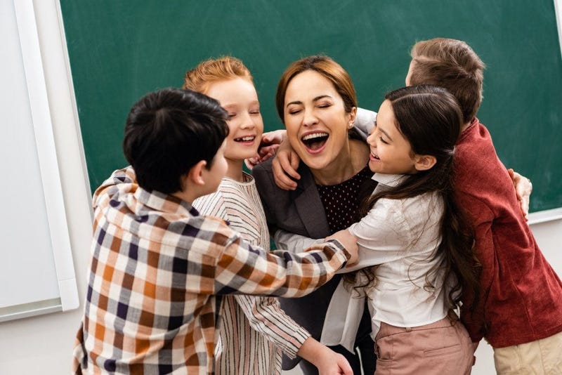 teacher hugging students
