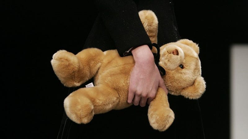 A close up of a model carrying a teddy bear on the runway at the Jennifer Nicholson Fall 2006 show during the Mercedes Benz Fashion Week at Smashbox Studios on March 22, 2006 in Culver City, California.
