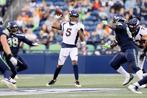 Teddy Bridgewater drops back to pass in a Broncos game.