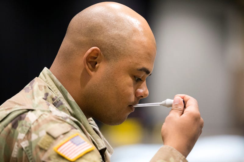 Military personnel, including Brandon Lawrence from Tacoma, Washington seen checking the accuracy of a thermometer, sets up the 627th Hospital Center field hospital at CenturyLink Event Center on March 31, 2020 in Seattle, Washington. 