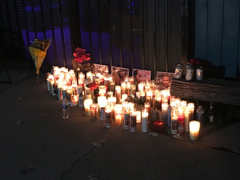 Candles burn outside Tequila KC, where four men were gunned down