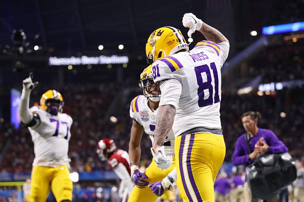 Thaddeus Moss points to the name on the back of his jersey. 