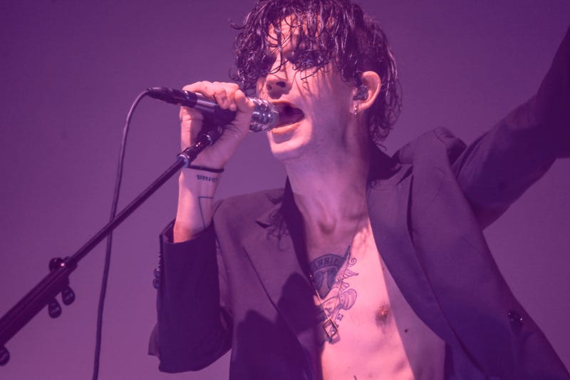 Matty Healy from The 1975 sings on stage