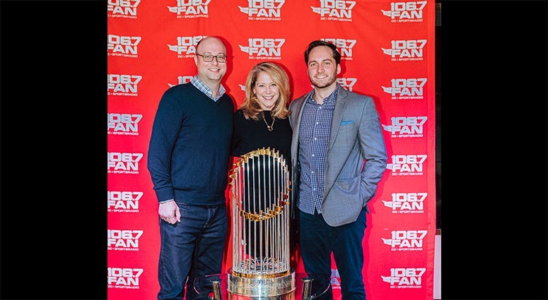 106.7 The Fan station management poses with The Commissioner's Trophy