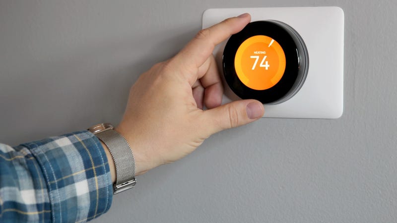 Man is Adjusting a temperature in modern living room