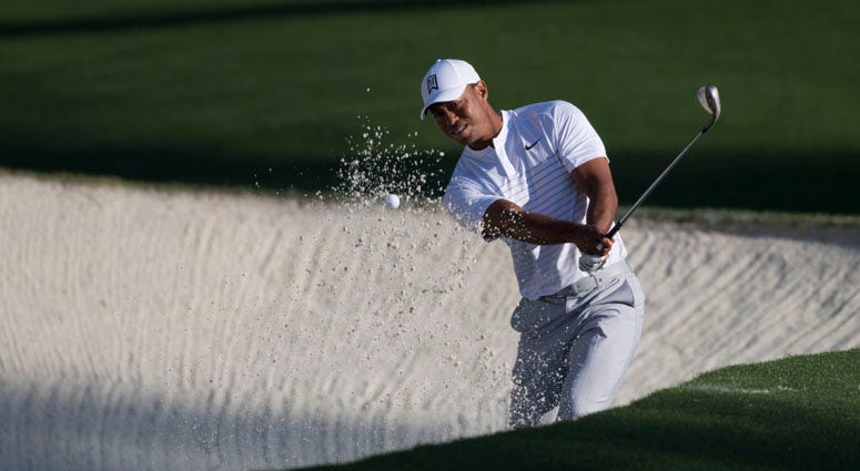 Tiger Woods hits from the sand at 10 during a practice round for the Masters on April 3, 2018, at Augusta National.