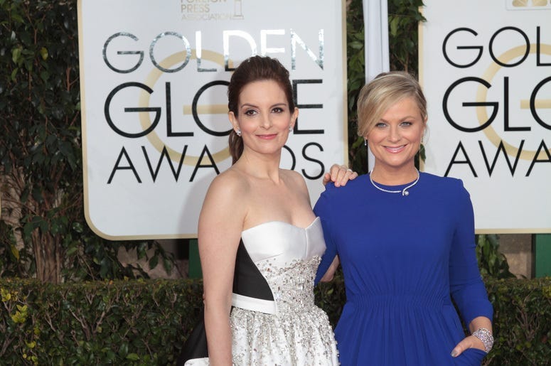 Actress and Co-Host Tina Fey and Amy Poehler arrive at the 72nd Annual Golden Globe Awards