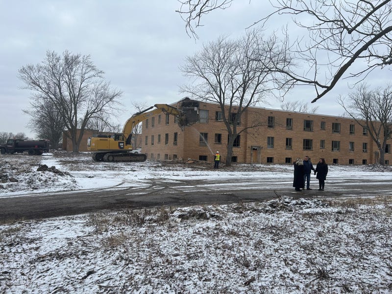 Excavator begins to demolish building