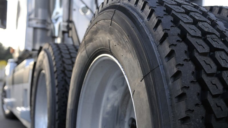 The tires and rims of a big rig semi truck