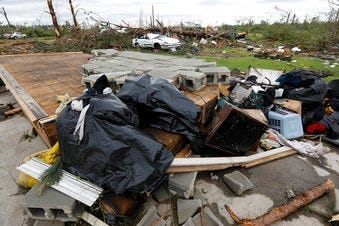 Bags of recovered clothing rest on what remains of the floor in Mama D's Bar and Grill in Bassfield, Miss., Monday, April 13, 2020. (AP Photo/Rogelio V. Solis)