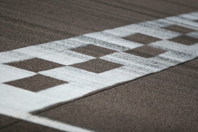 The painted start/finish line across a racetrack