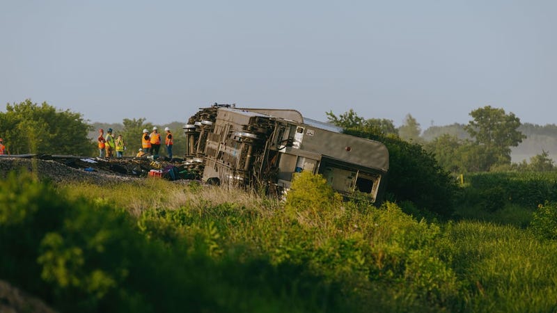 Railroad workers work the scene where an Amtrak train derailed on June 27, 2022 in Mendon, Missouri. 