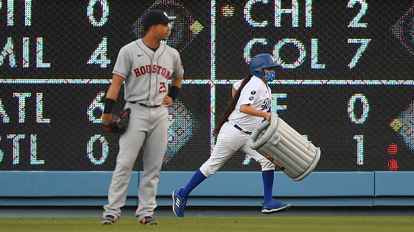 Dodgers fans toss inflatable trash cans onto field while taunting Astros
