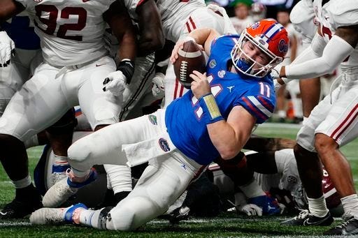 Florida quarterback Kyle Trask (11) leaps into the end zone for a touchdown against Alabama during the first half of the Southeastern Conference championship NCAA college football game, Saturday, Dec. 19, 2020, in Atlanta.