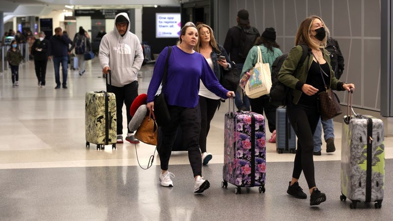  Airline passengers without face masks walk through San Francisco International Airport on April 19, 2022 in San Francisco, California. 