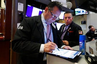 Traders Edward Curran, left, and Jonathan Mueller work on the floor of the New York Stock Exchange, Thursday, March 12, 2020. (AP Photo/Richard Drew)