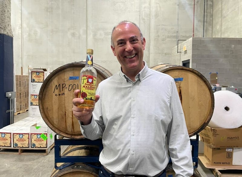 Distiller holding bottle of Malort