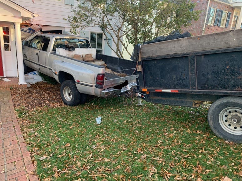 Truck rolls into home, no one injured
